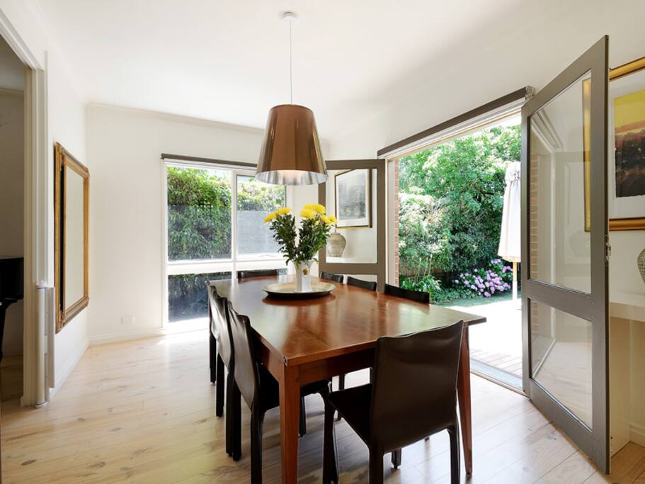 The perfect space for a dinner party with everything you need for entertaining! Easily accommodates dinner for 8 people with placemats, linen napkins and beautiful dinner and glass ware. The doors can be opened on warm nights for a lovely ambience and indoor outdoor entertaining.