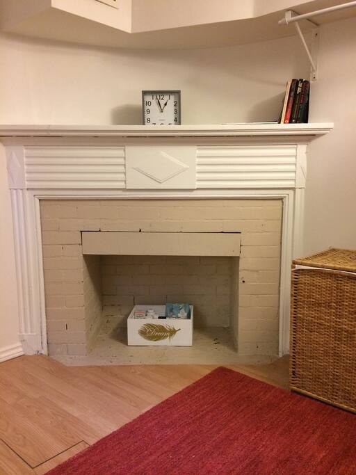 The bedroom has a sweet (non-working) fireplace that can be used for books.