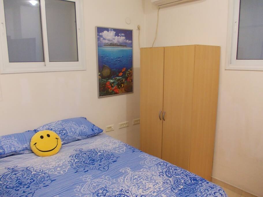 Comfy bed and closet shown. Air conditioning unit above works great.