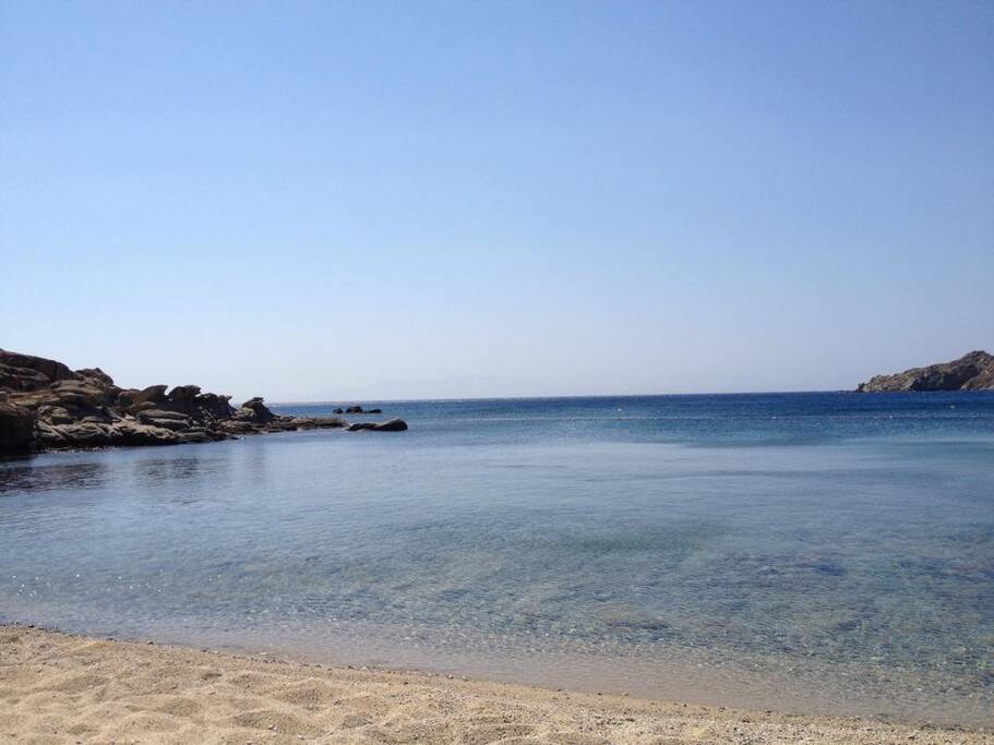 The resort's private beach with sunbeds and umbrellas