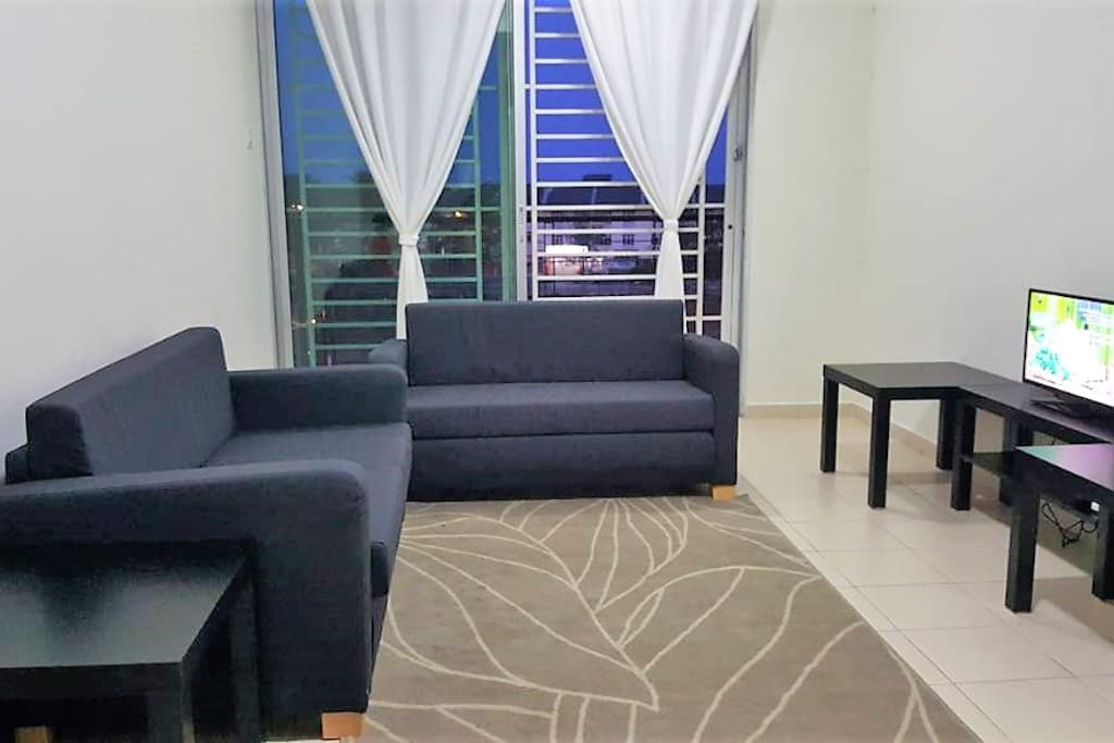 The living room is furnished with two sofa-beds