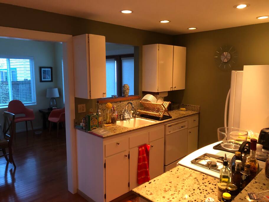 Kitchen comes stocked with plates, glasses and pots.