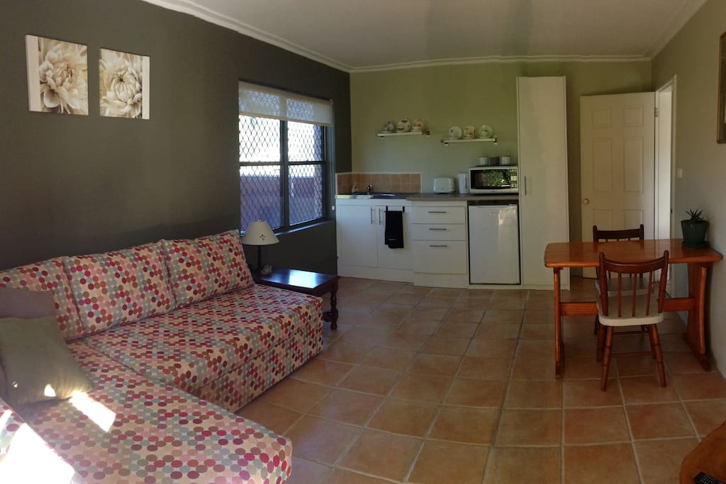 Lounge area with kitchenette and dining table