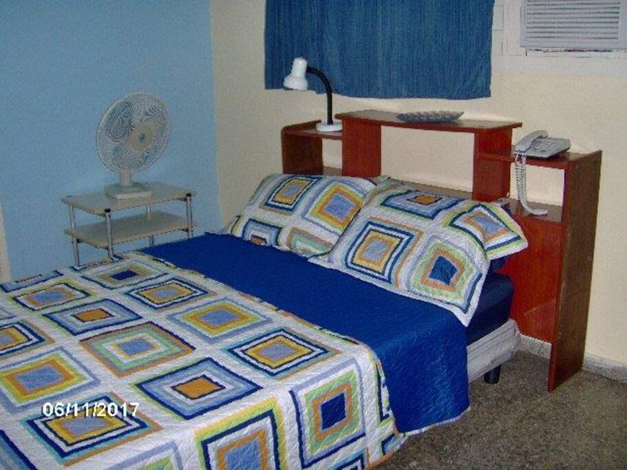 Room 1. Queen size bed, AC, fan and storage space