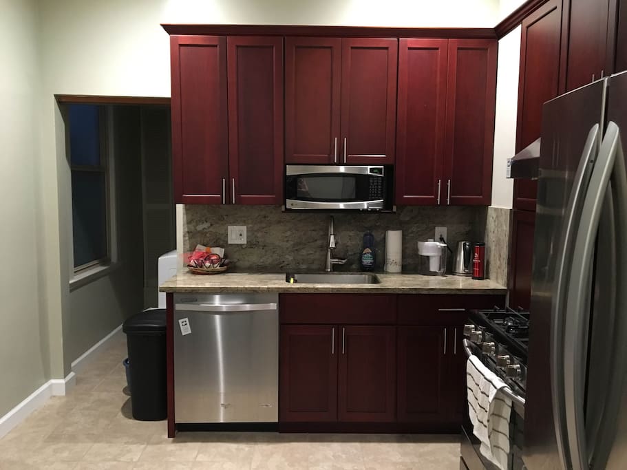 Remodeled, fully stocked spacious kitchen with modern stainless steel appliances.