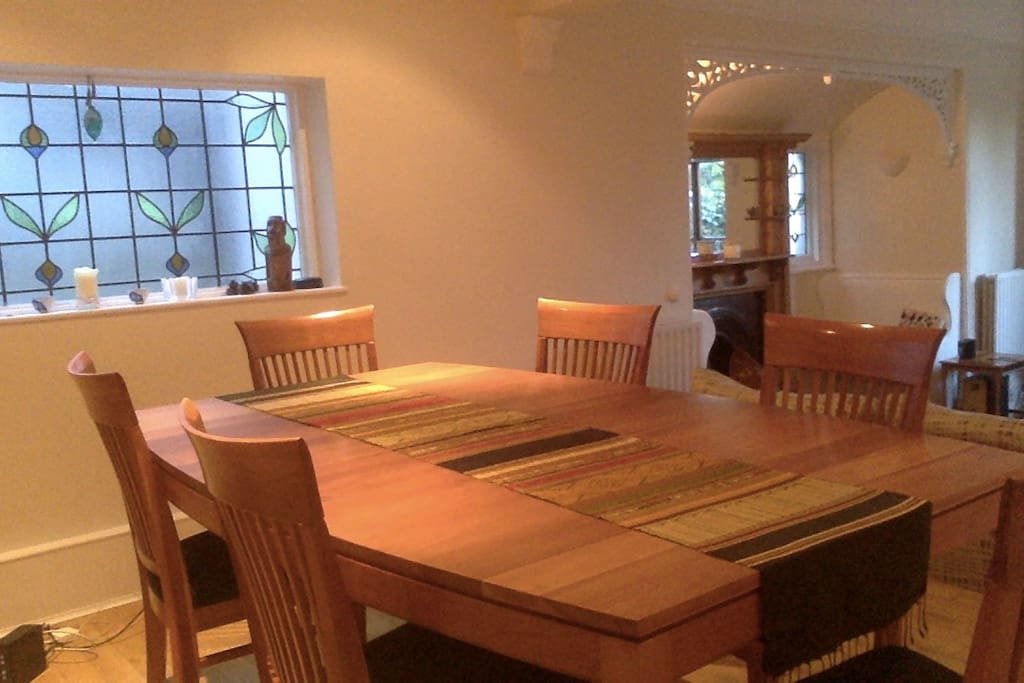Dining and lounge open to leafy garden.