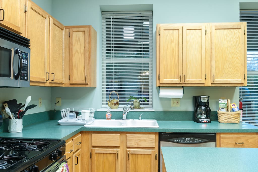 Prepare meals or grab a drink in our full kitchen featuring a dishwasher, oven/stove, microwave, and refrigerator.