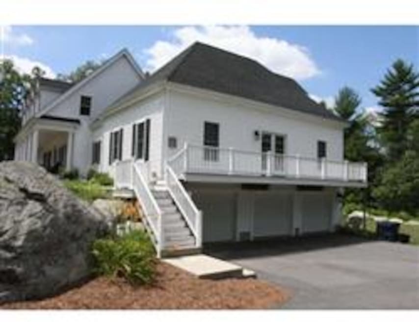 Exterior of full apartment with side deck and french doors and many windows to view the lovely scenery.