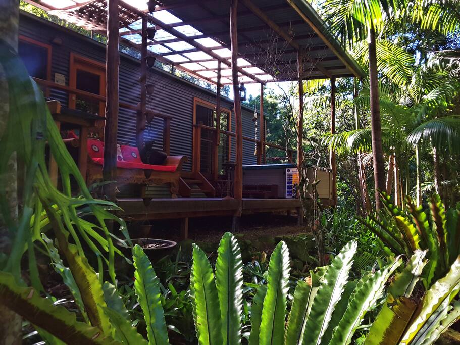 View of the deck and daybed from the creek and garden.