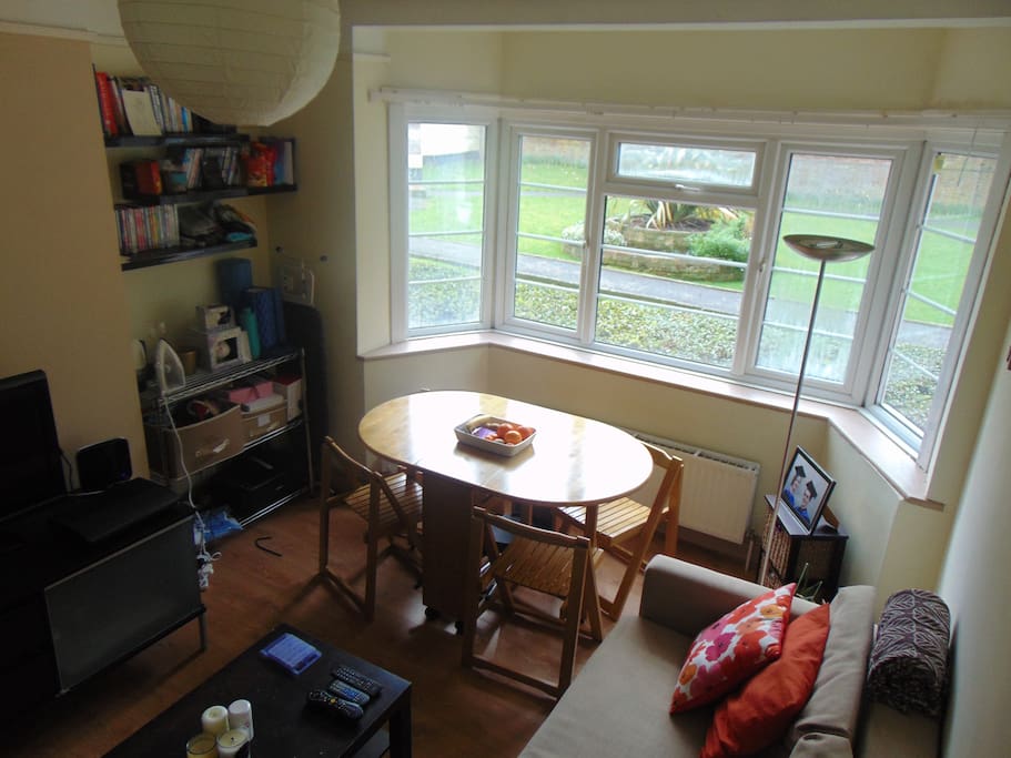 Sitting room: brand new double IKEA sofa bed, TV and DVD player, wooden table with chairs, wide bay windows with bright view on the lovely court and its garden