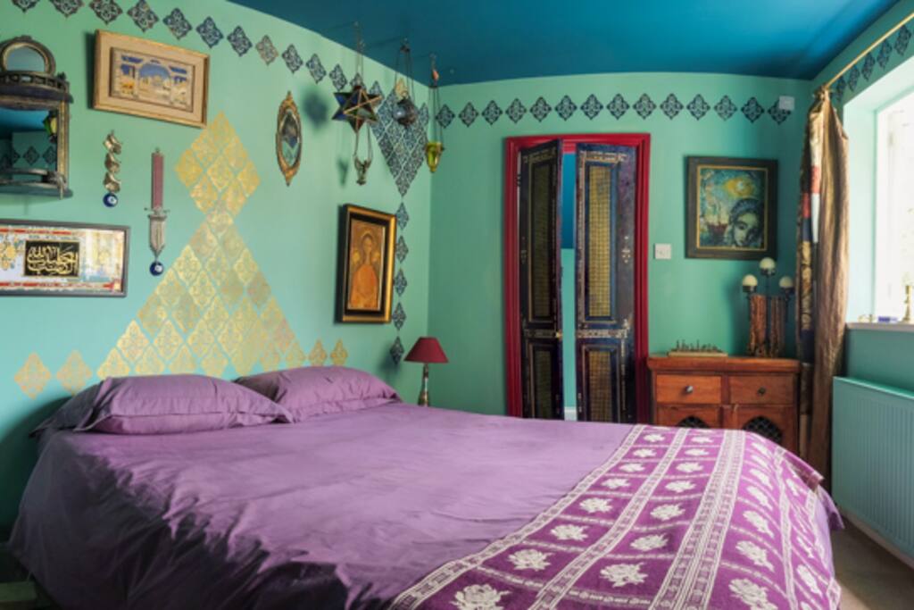 The double doors at the back of the room are the bathroom