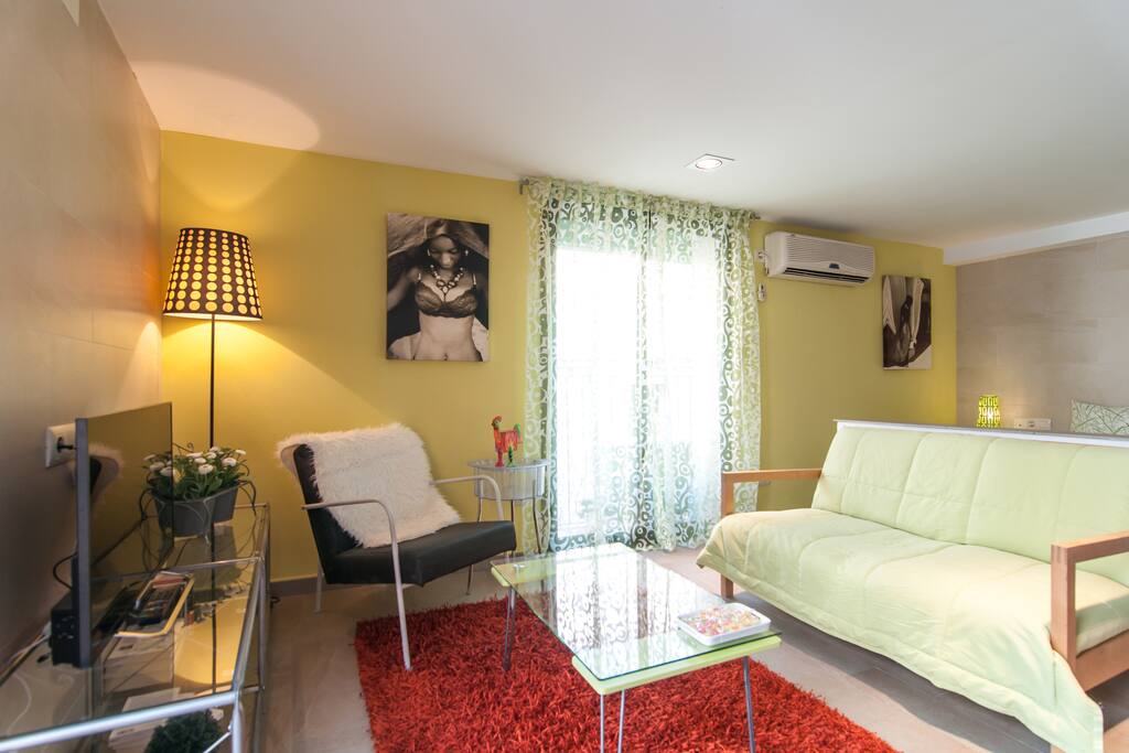 Living room and bedroom share the same space but in very different environments.