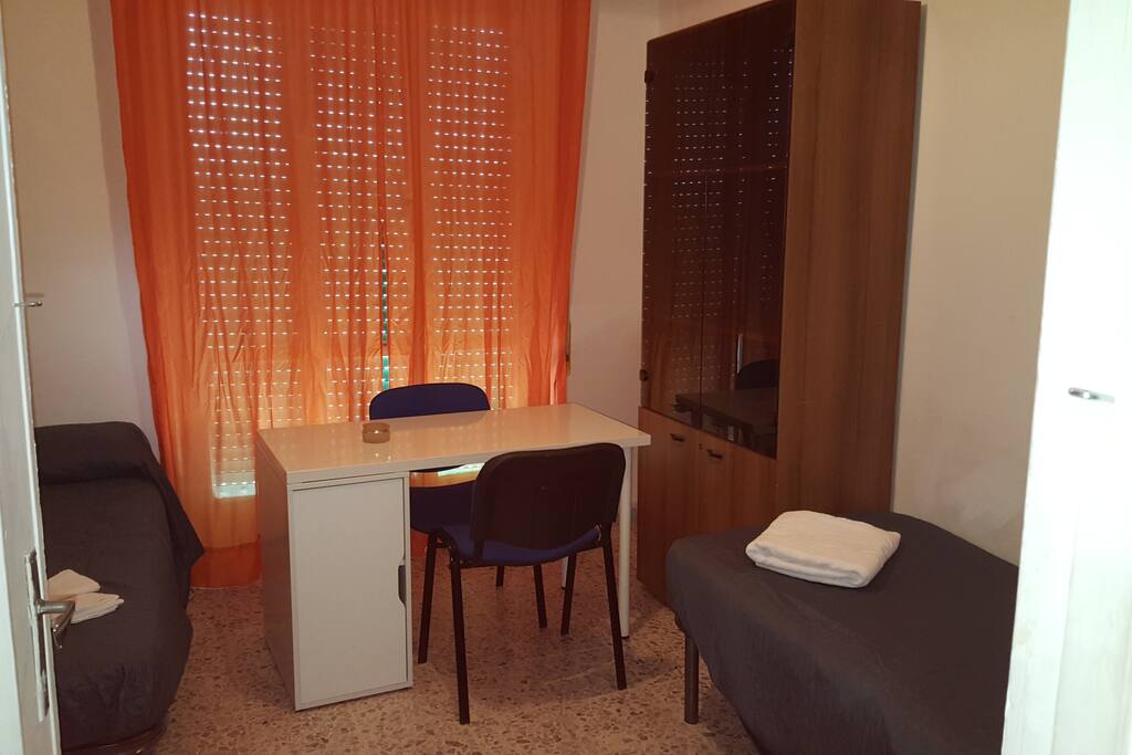 2 letti , armadi e scrivania. stanza con balcone