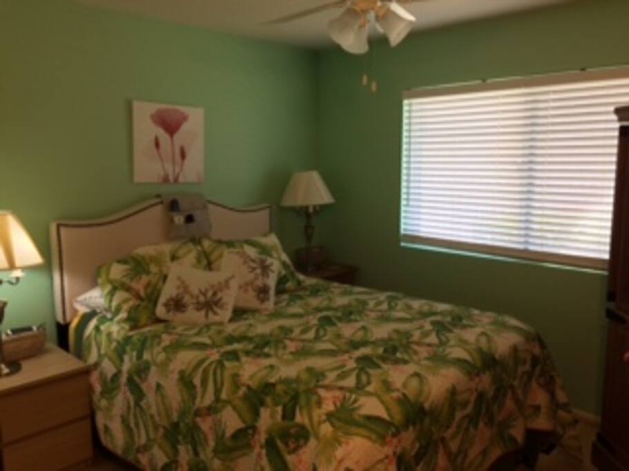 The master bedroom includes a very comfortable queen-sized bed and large TV cabinet.