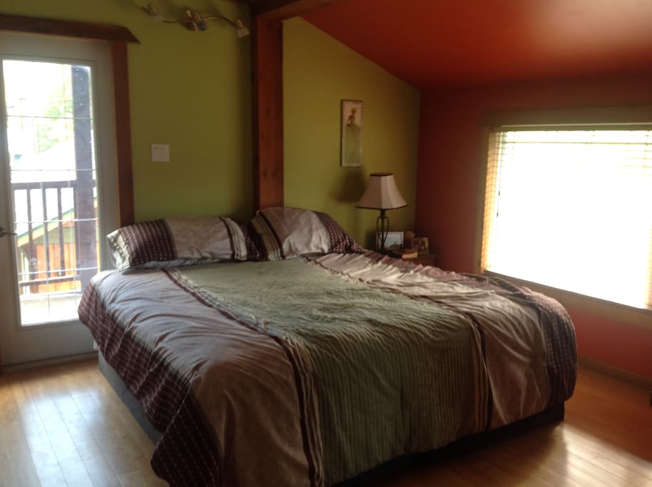 Master Bedroom with balcony and king bed