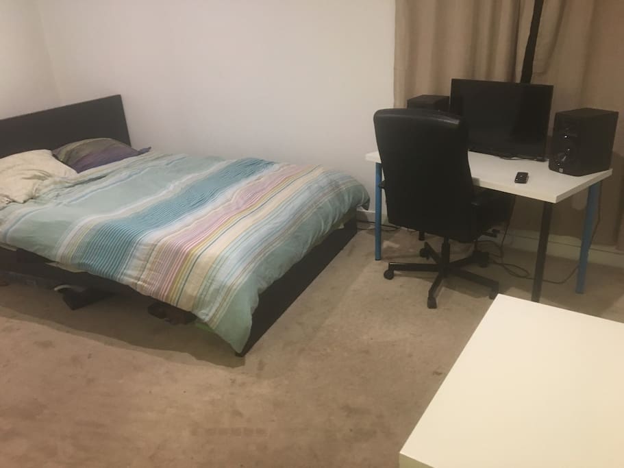 Single Bedroom with a window, TV, and bathroom