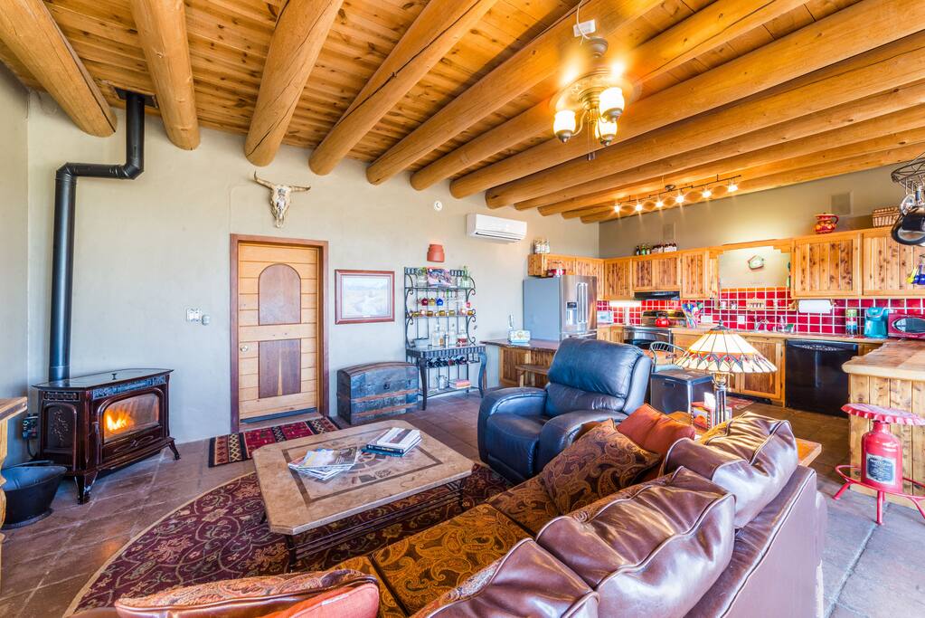 Cedar vigas. Custom artwork and woodwork throughout. Leather recliner.