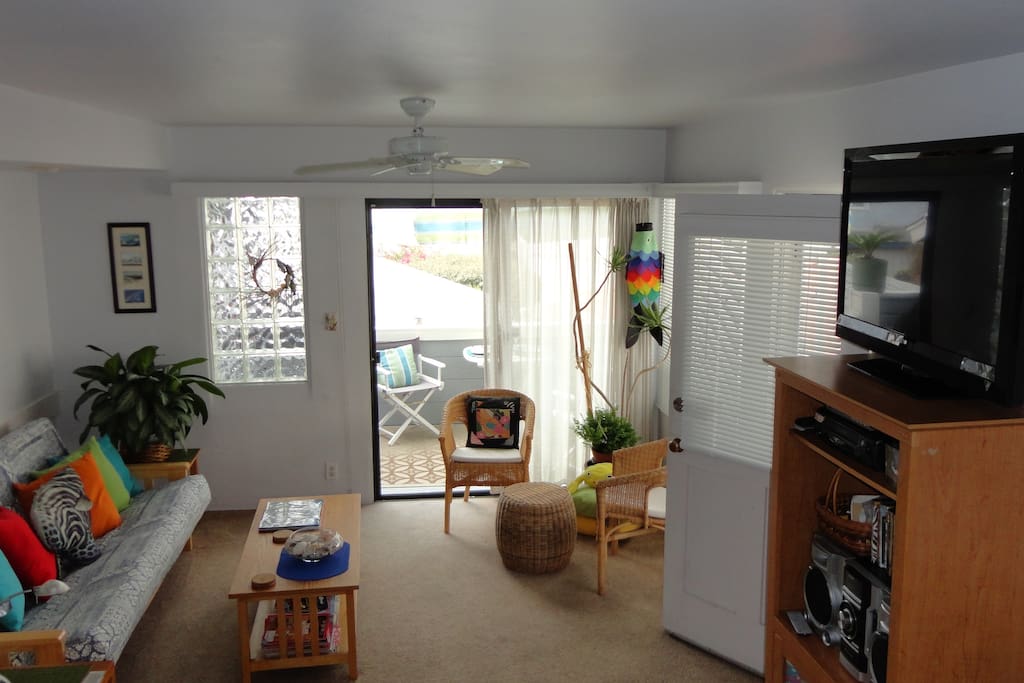 Living room has double futon entertainment center and access to exclusive use deck.
