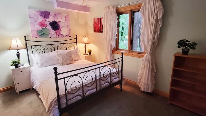 Fourth bedroom with comfortable queen bed and ceiling fan