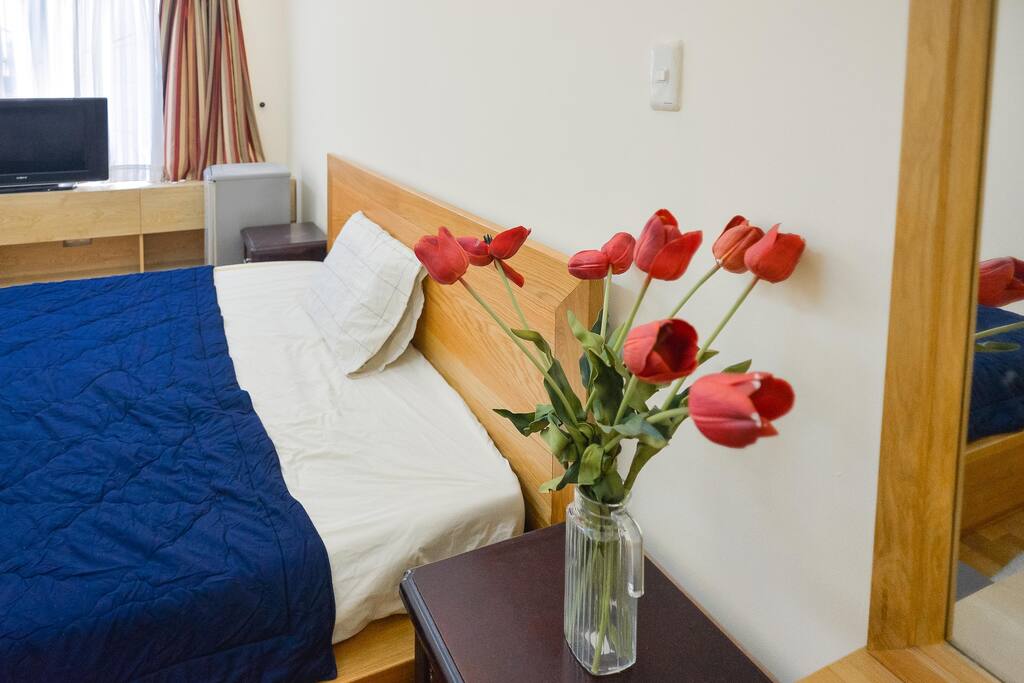 The double bed is near to work desk and make-up desk.