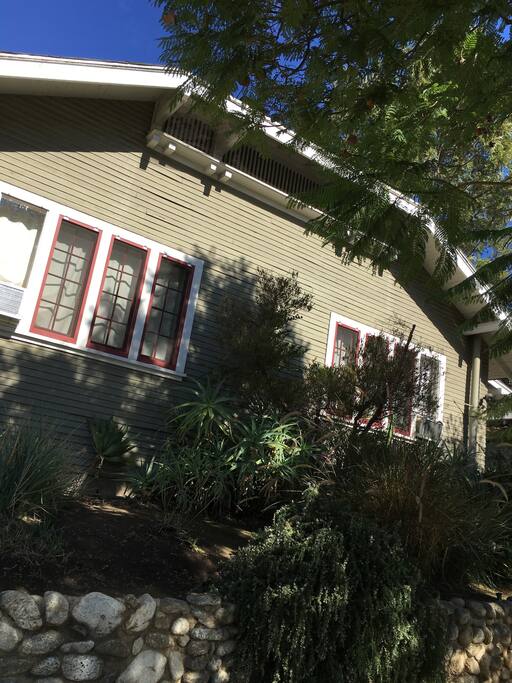 The house rises above the street on a mound that is held up by retaining walls. It affords a great deal of shaded privacy from the rest of the neighborhood.