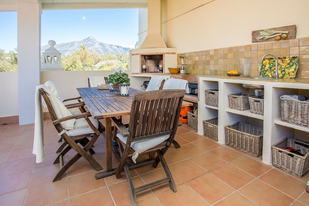 West facing terrace with outdoor kitchen .