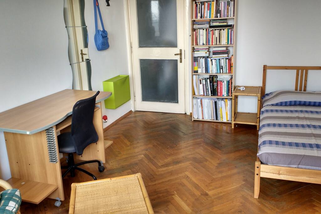 desk with office chair, mirror, third shoe rack, some hangers