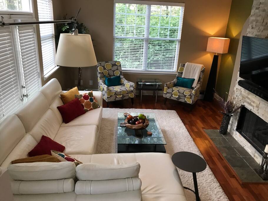Living room has plenty of seating, as well as a flat-screen TV and fireplace.