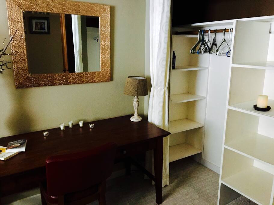 Open closet space to hang /store your clothes- hamper included. Wall hooks to hang your towels~