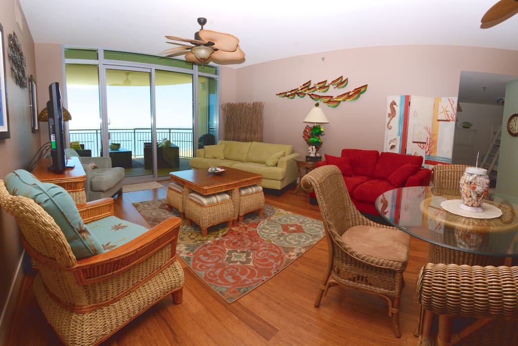 Living area with view of the Gulf - red foldout couch.