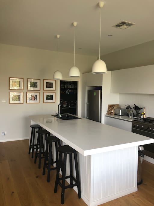 Open plan kitchen and pantry with oven fridge freezer and microwave