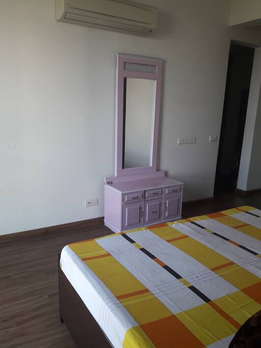 Spacious room with mirror and hard wood floor