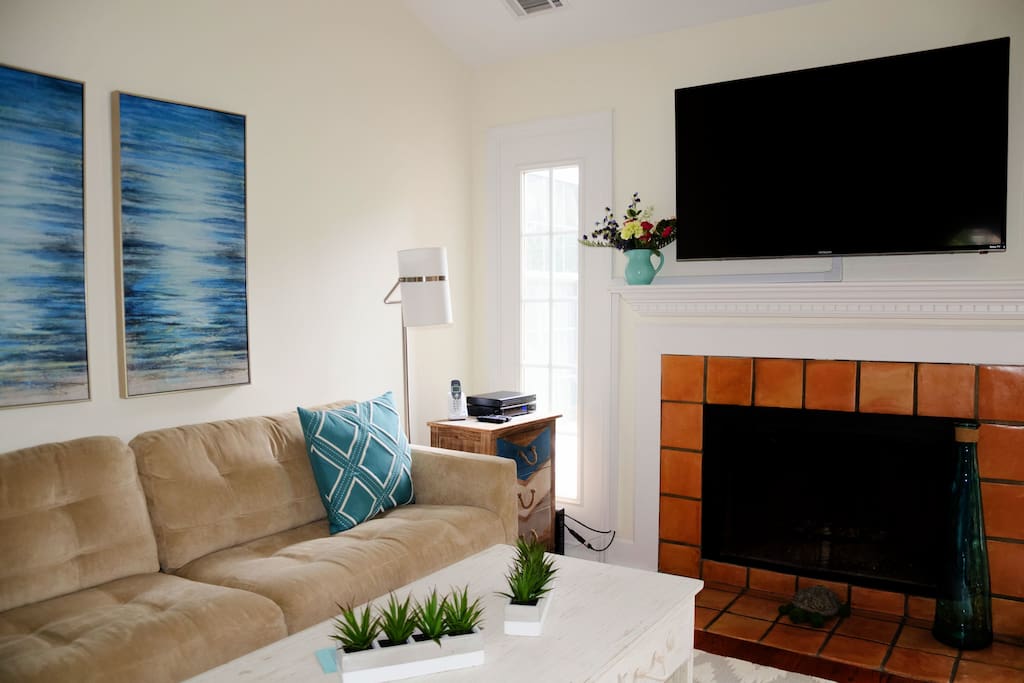 The living room is very inviting and comfortable furnishings, with a new large flat screen over the fireplace.
