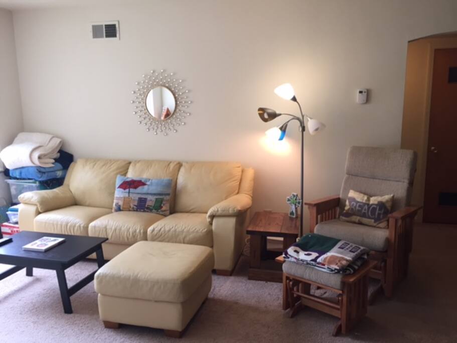 Large living area with a comfortable couch and TV.