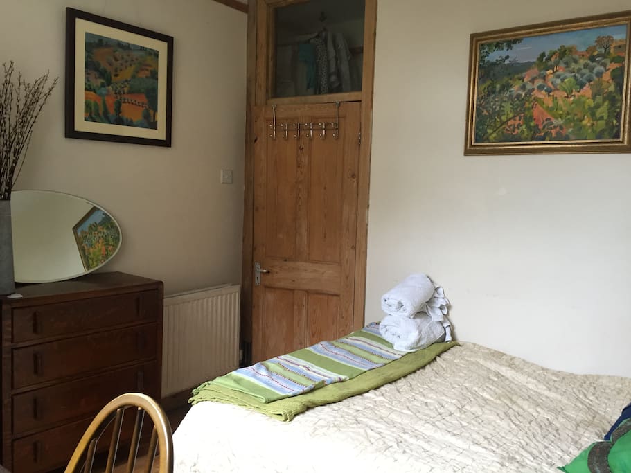 clean towels, hooks and a quiet and calm light comfortable bedroom with light blocking curtains.