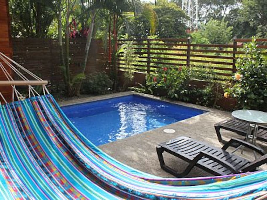 Lay on the hammock and watch the kids swim.