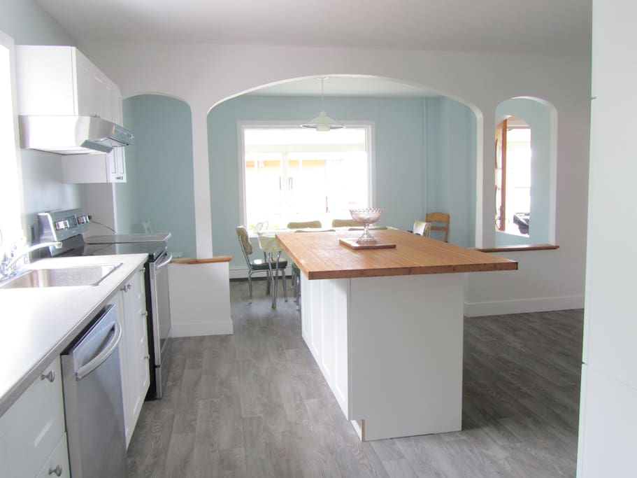 Big bright and brand new kitchen with stainless steel appliances