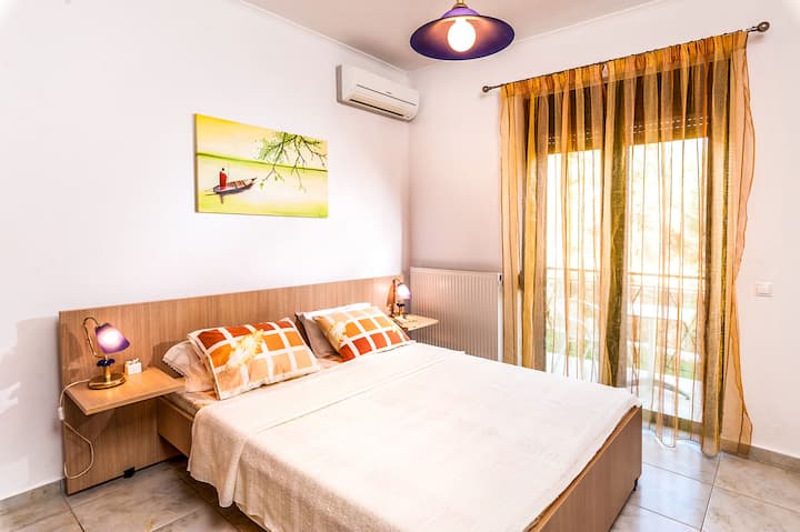 Ground Floor: Bedroom 1 with queen bed and private balcony.