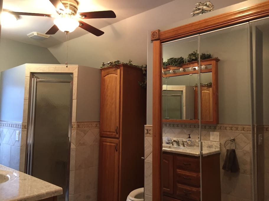 Upstairs double shower head enclosed tiled shower full bathroom