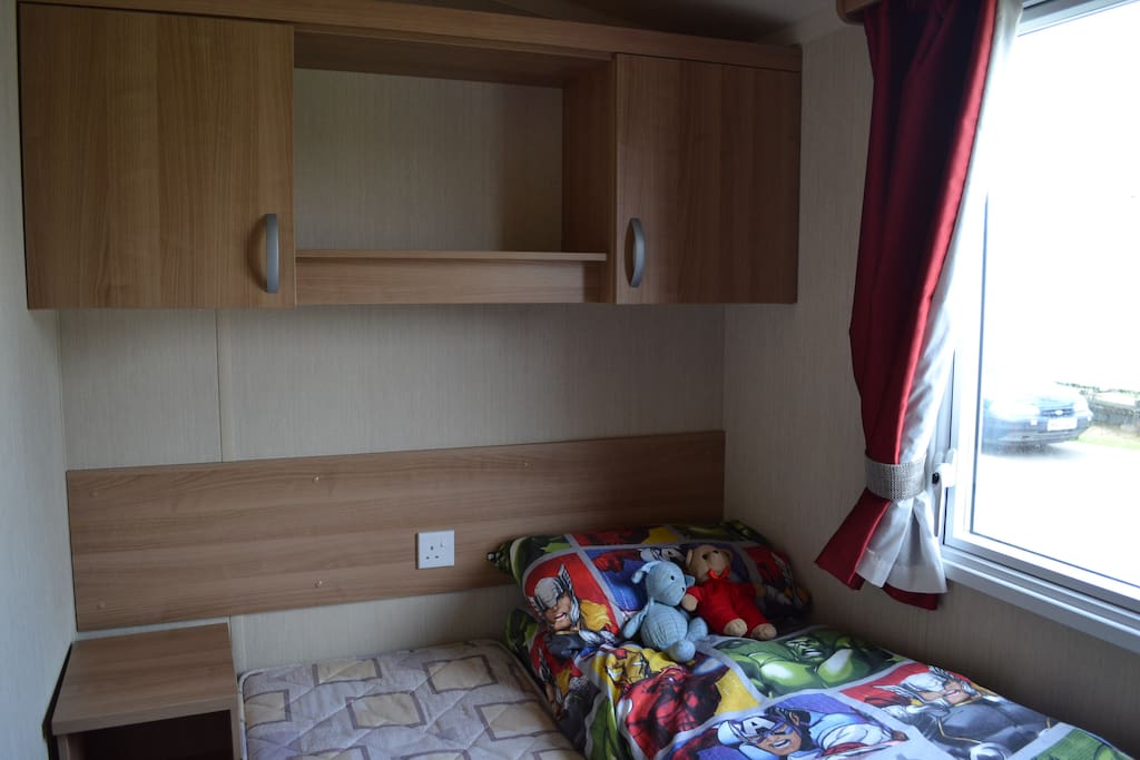 Second bedroom with 2 single beds, which can be pushed together. Cupboards, wardrobe and bedside table.
