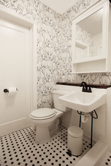 Designer-renovated bathroom with large subway-tiled shower.