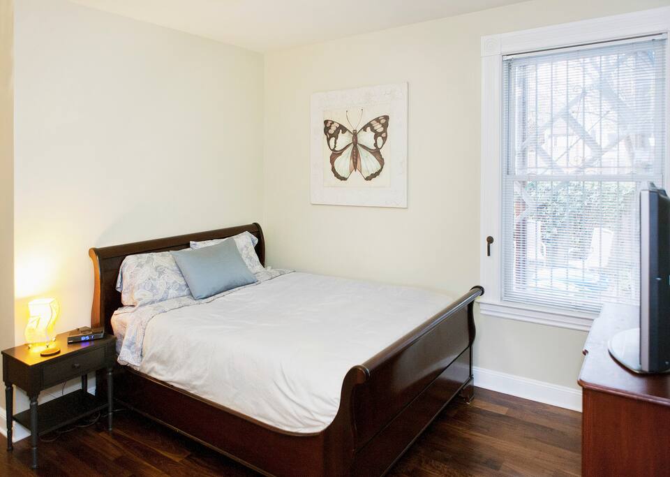 This is the room viewed from your private/separate entrance, with a comfortable queen sized bed and beautiful walnut hardwood floors.