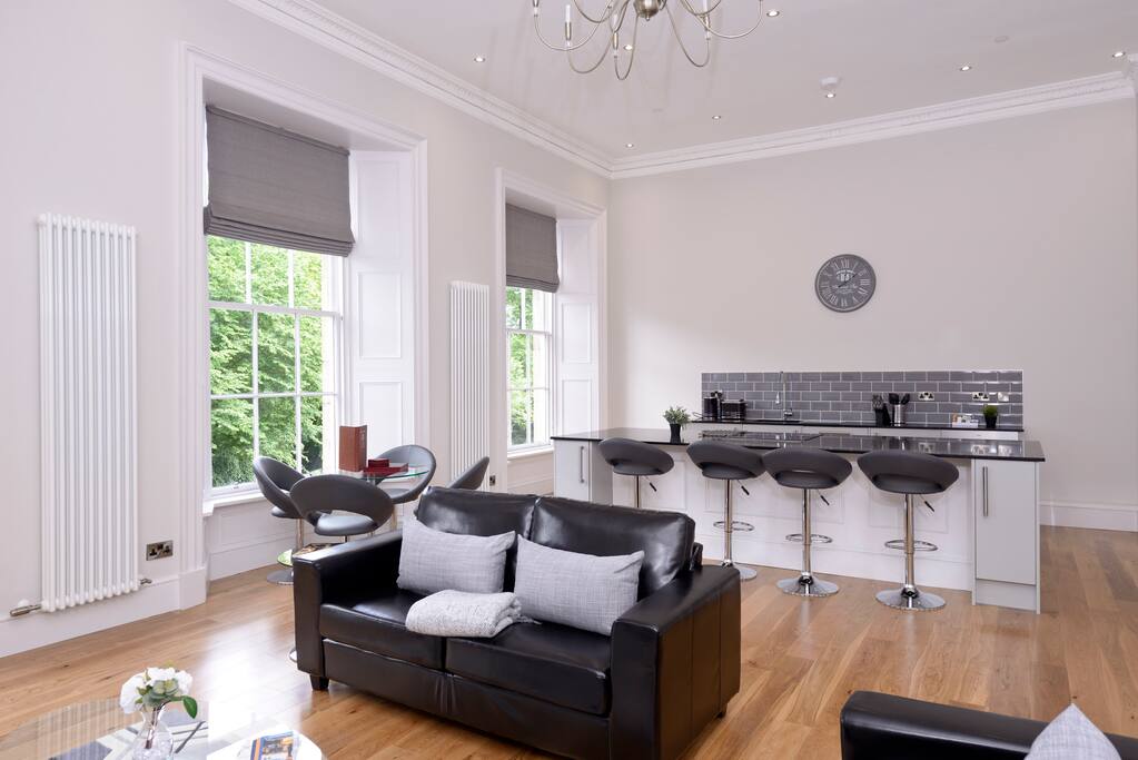 Comfortable Living Room with Leather Sofas and Dining Table
