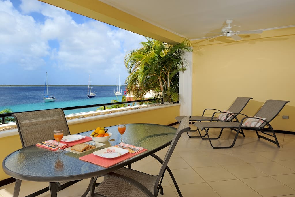 Covered large porch with 6 dining chairs and 2 lounge chairs