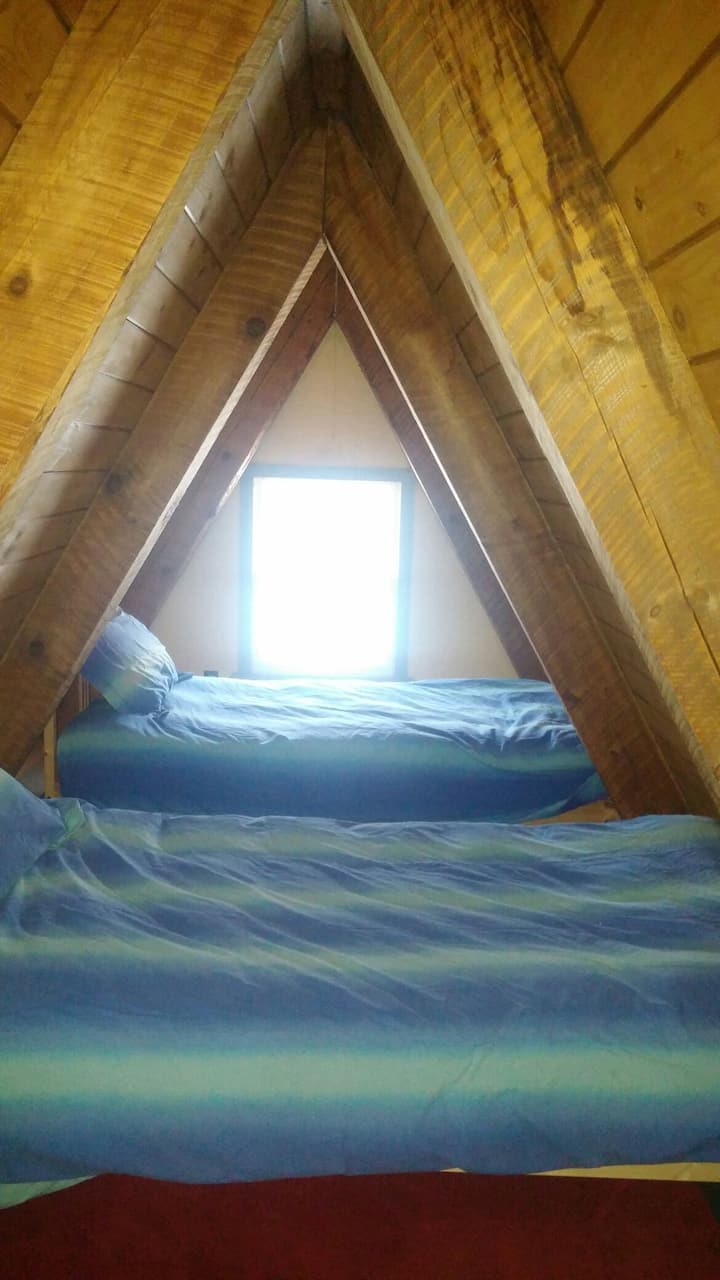Sleeping Loft is listed as a 3rd bedroom. It is open with a railing overlooking the living area. 2 twin beds.