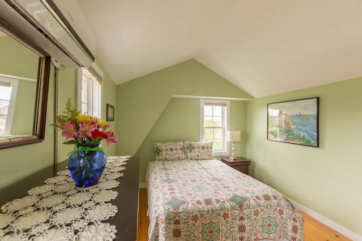 Primary bedroom in main house. Queen size bed, plenty of storage, attached shared bath. This is on the second floor of the main house.