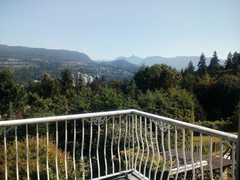 View off living room deck of Newport village, Heratige Mountain and Golden Ears beyond.