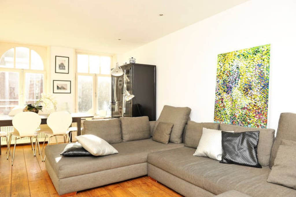 Very bright living room with open kitchen and great sofa