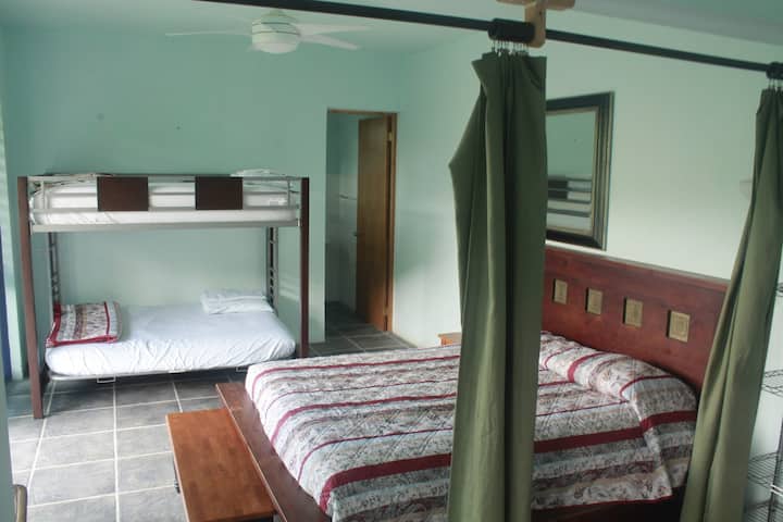 The classic suite with the bunk bed pictured and bathroom entrance. The bathroom has hot water, flushing toilets, a sink, and shower! Fans are located in rooms for increased airflow too. 
