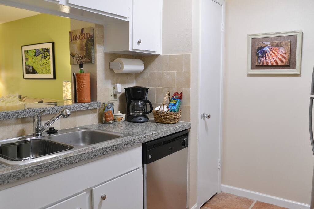 Kitchen with granite countertops, sink and dishwasher
